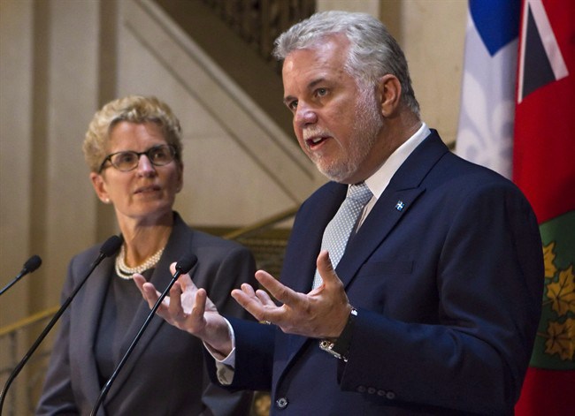 Quebec Premier Philippe Couillard addresses the Ontario legislature with Premier Kathleen Wynne